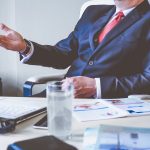 man in suit sitting at a desk