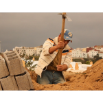 construction worker on sitting in a hole