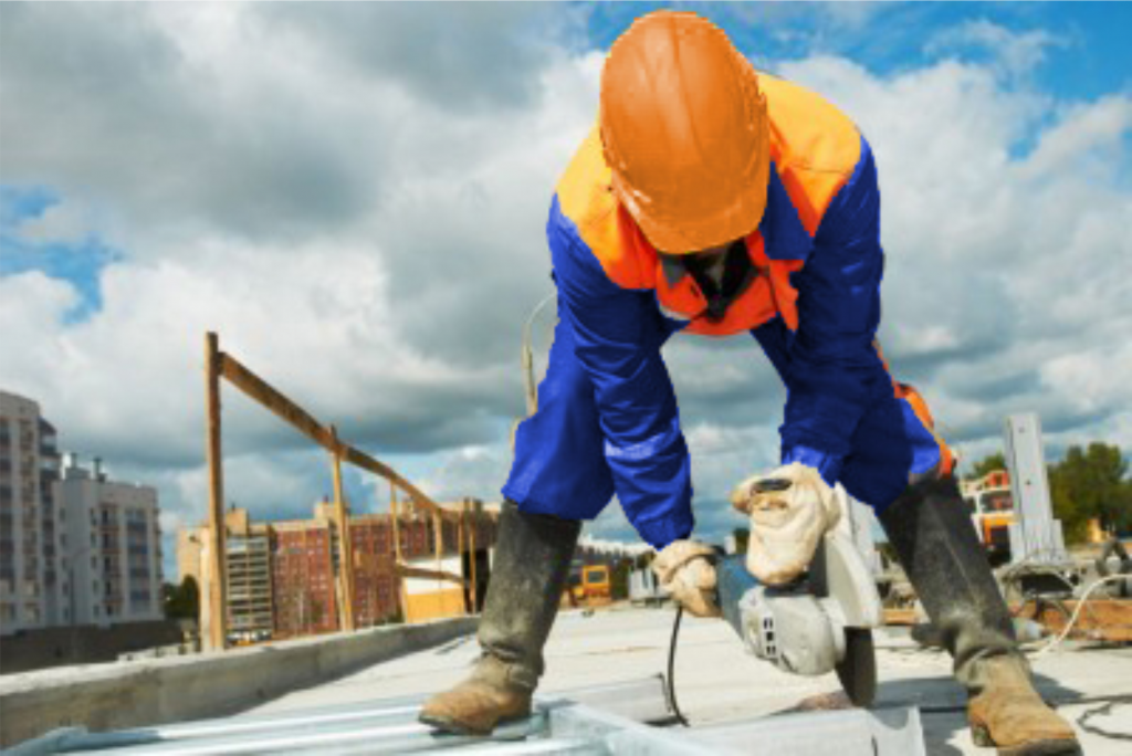 man using a circular saw on the roof